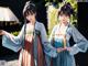 A couple of women dressed in traditional chinese clothing.